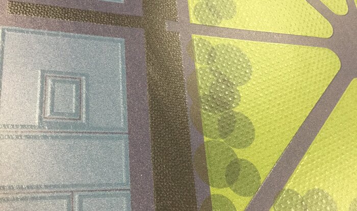 Close-up of a tactile print, showing buildings and a park.