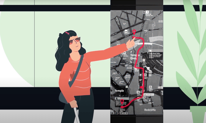 A cartoon showing a person with low vision touching a street map, which has a highlighted route plan.